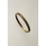 A YELLOW GOLD 15CT BANGLE