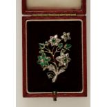 A DIAMOND AND EMERALD FLORAL SPRAY BROOCH