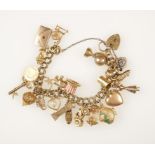 A YELLOW GOLD CHARM BRACELET