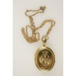 A VICTORIAN YELLOW METAL OVAL LOCKET