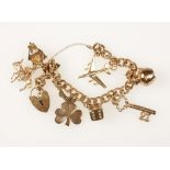 A 9CT YELLOW GOLD CHARM BRACELET