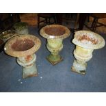 A PAIR OF 19TH CENTURY STYLE CAST IRON GARDEN URNS (17" high) and another (damaged)(3)