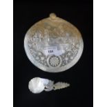 A DECORATIVE PIERCED MOTHER-OF-PEARL BAPTISMALSHELL decorated with a scene of the Nativity and a