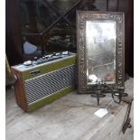 A BRASS FRAMED WALL MIRROR with candle sconces and a vintage 'Roberts' radio