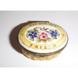 AN ENAMELLED PATCH BOX, the lid decorated with flowers 'The Gift of a Friend'