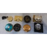 A COLLECTION OF GOLD COLOURED LADIES COMPACTS, some enamelled or paste-set