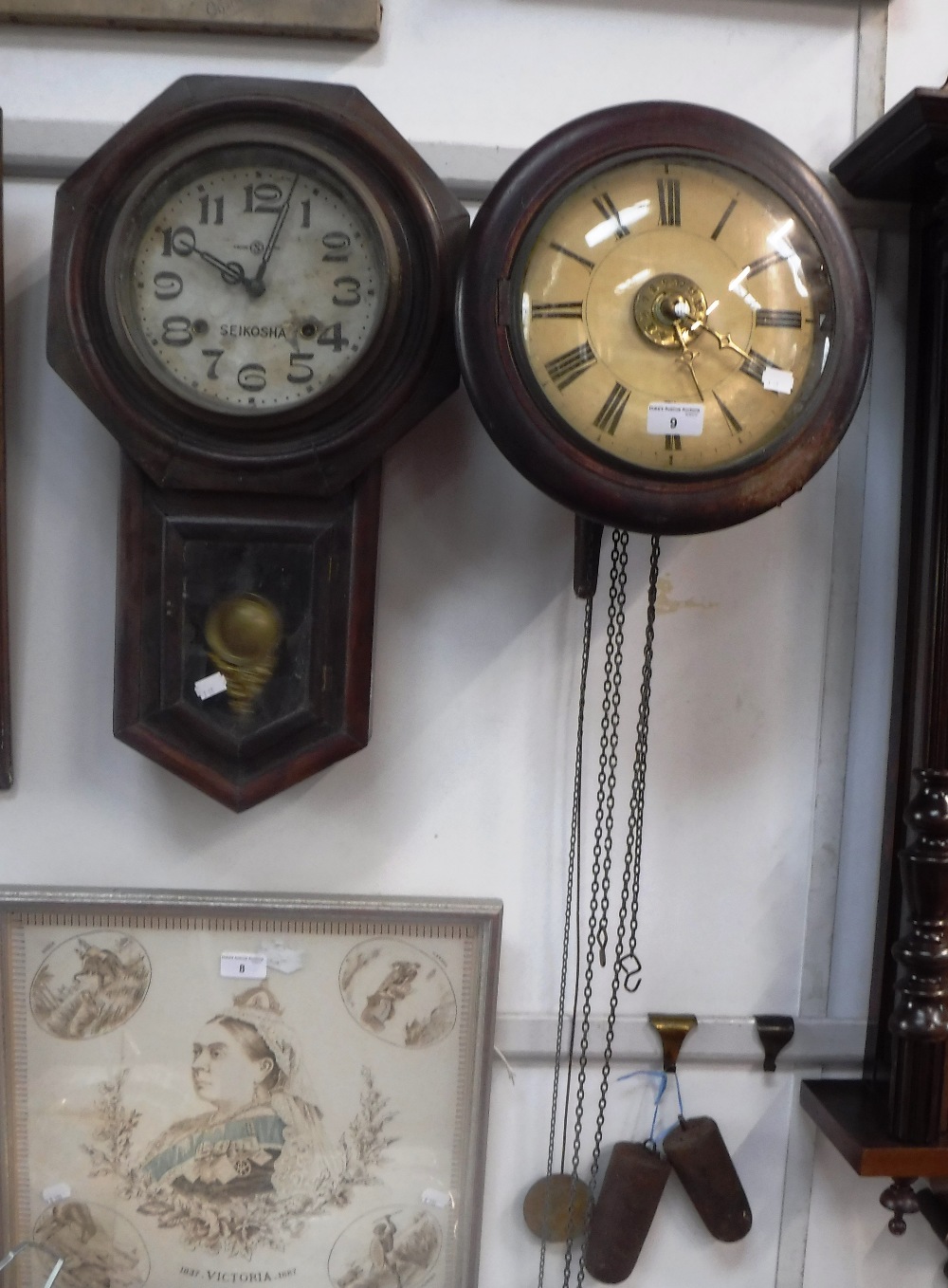 A 19TH CENTURY 'POSTMAN'S ALARUM' CLOCK with painted circular dial and a 'Seikosha' drop-dial wall