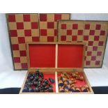 A FOLDING CHESS BOARD containing a turned wooden chess set and another similar board