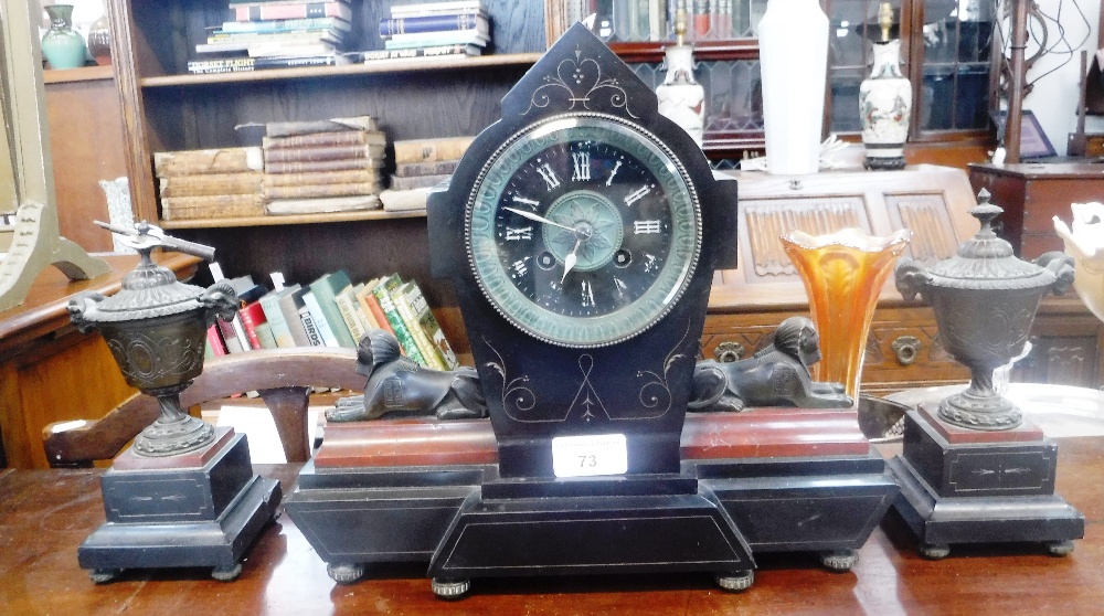 A 19TH CENTURY 'EGYPTIAN REVIVAL' CLOCK, the polished black slate case flanked by brass sphinx on