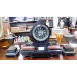 A 19TH CENTURY 'EGYPTIAN REVIVAL' CLOCK, the polished black slate case flanked by brass sphinx on