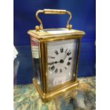 A FRENCH BRASS-CASED CARRIAGE CLOCK with white enamel dial