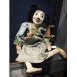 AN EASTERN PUPPET with white painted face and articulated limbs and hands