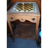 AN OAK GAMES TABLE with Gothic pierced detail and reverse-painted and gilt chessboard top