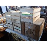 A VINTAGE WOODEN PACKING CRATE with rope handles and five wooden fruit crates
