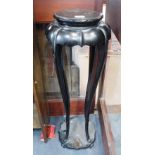 AN ORIENTAL EBONISED HARDWOOD STAND OF ELONGATED LOTUS FORM, 33" high