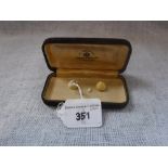 A MINIATURE BONE EGG PENDANT with enclosed chick