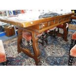 A SPANISH STYLE REFECTORY TABLE with scrolling iron stretcher 63" long