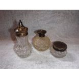 A SILVER TOPPED PERFUME BOTTLE and two other similar items