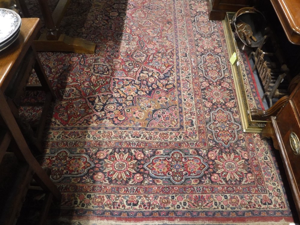 A LARGE RED GROUND PERSIAN DESIGN CARPET with all over stylised floral decoration, approx. 160" x