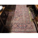 A LARGE RED GROUND PERSIAN DESIGN CARPET with all over stylised floral decoration, approx. 160" x