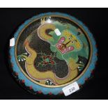 A CHINESE CLOISONNE BOWL decorated with a dragon against a black ground