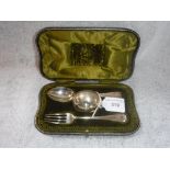 A SILVER SPOON, FORK AND NAPKIN RING in a fitted presentation case