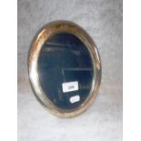 A SILVER PHOTOGRAPH FRAME of oval form