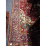 A PERSIAN CARPET, the centre worked with geometric flowers within conforming surround in blues,