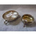 A MINIATURE SHALLOW DISH on three scrolling feet and a silver salt (2)