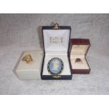 TWO YELLOW METAL DRESS RINGS and a silver Wedgwood brooch (3)