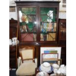 A GEORGE III MAHOGANY LIBRARY BOOKCASE with astragal glazed doors and cupboard below, 52'' wide, and