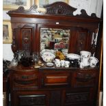 AN EDWARDIAN WALNUT SIDEBOARD with carved decoration and mirrored back 60" wide
