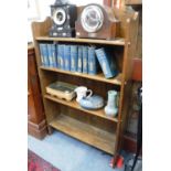 AN OAK ARTS & CRAFTS STYLE OPEN BOOKCASE with arched top 30.5" wide