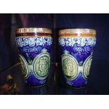 A PAIR OF DOULTON LAMBETH 'VICTORIA JUBILEE' BEAKERS with silver rims