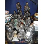 A COLLECTION OF BRONZE EFFECT RESIN FIGURES to include lovers and fishermen