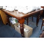 A LATE VICTORIAN WALNUT EXTENDING DINING TABLE on reeded legs with wind-out action extending to 57"