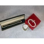 A SINGLE STRAND CULTURED PEARL NECKLACE, a pair of similar earrings and a bracelet (3)