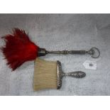 A SILVER HANDLED RED FEATHER DUSTER and a crumb brush (2)