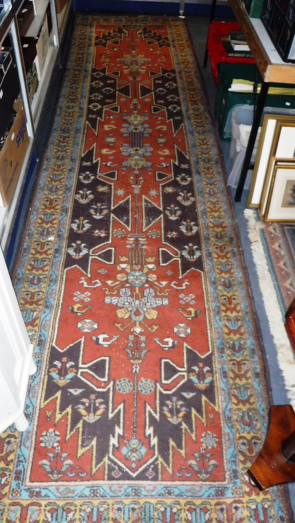A GEOMETRIC RUNNER, the central field with geometric panels with abstract and foliate motifs