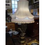 A GILT METAL TABLE LAMP in the form of an eagle, with a fringed silk shade