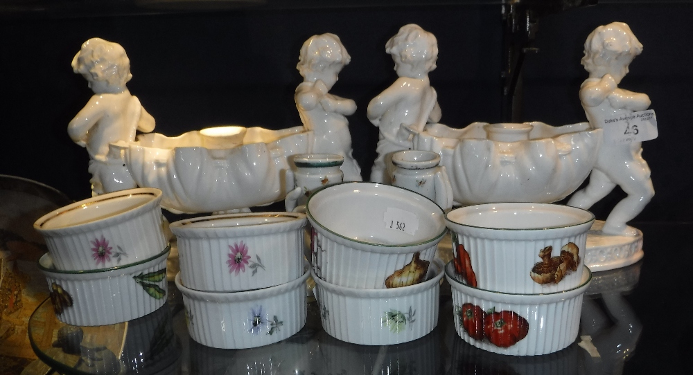 A PAIR OF WORCESTER CENTRE PIECES, each of a basket supported by cherubs, with an internal