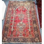 A RED GROUND PERSIAN PRAYER RUG with floral design, 35" x 80"