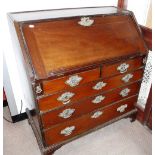 A GEORGE III MAHOGANY BUREAU with pierced brass escutcheons and back plates 37" wide