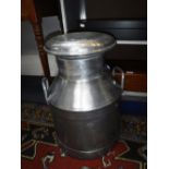 A POLISHED ALUMINIUM MILK CHURN