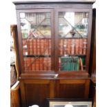 A GEORGE III MAHOGANY LIBRARY BOOKCASE with astragal glazed doors and cupboard below, 52" wide and a