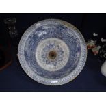 A 19TH CENTURY TRANSFER DECORATED CIRCULAR WASH BASIN with plug-hole, 12.5" dia