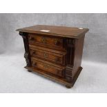 A 19TH CENTURY CONTINENTAL OAK MINIATURE CHEST OF THREE DRAWERS