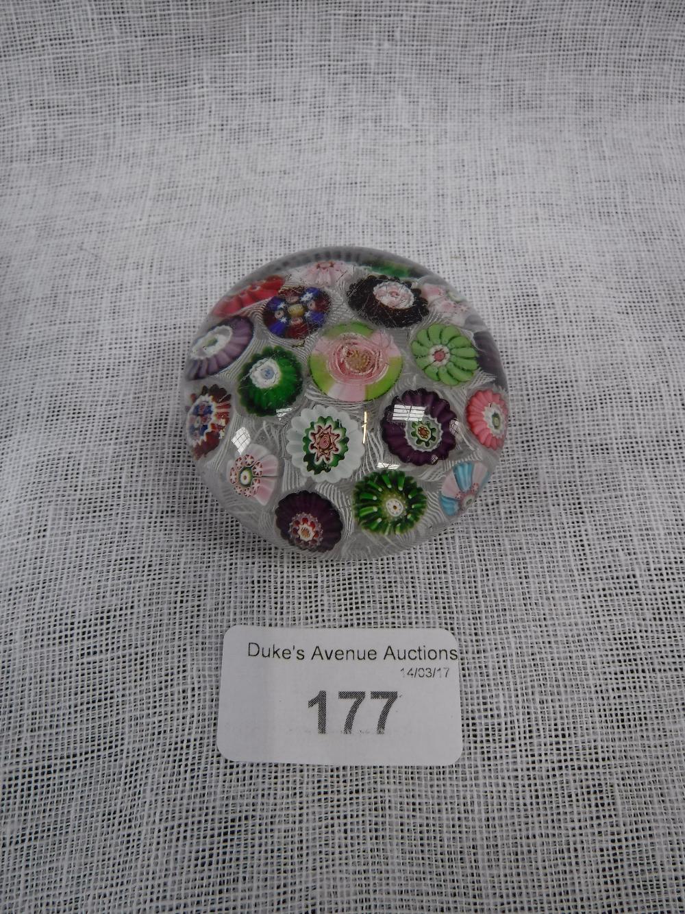 A SMALL PAPERWEIGHT with floral canes against a lacy white ground