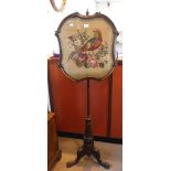 A 19TH CENTURY WALNUT POLE SCREEN with a needlework panel depicting a pheasant with flowers