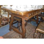 A SPANISH STYLE REFECTORY TABLE with scrolling iron stretchers, 63" long